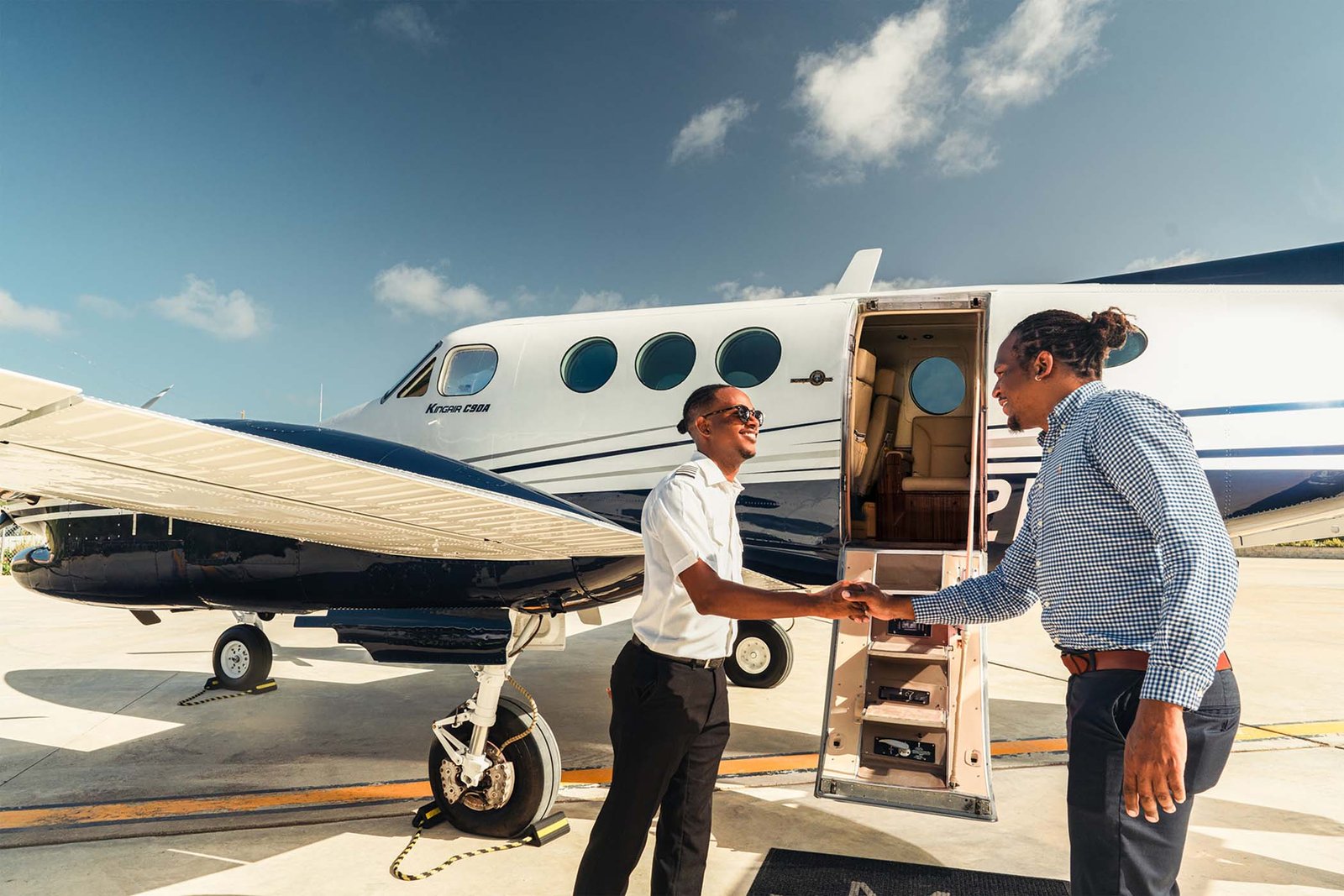 Privatelink Aviation pilot greeting a guest before a corporate charter flight.